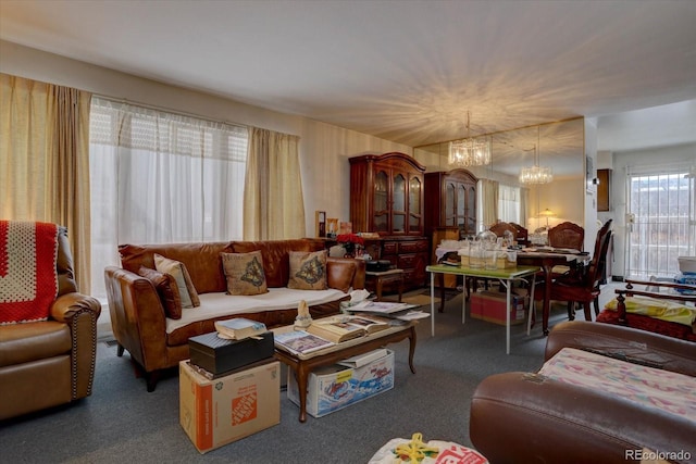 living room featuring a chandelier and dark colored carpet