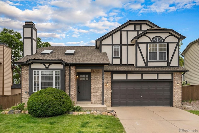 tudor house with a garage and a front lawn