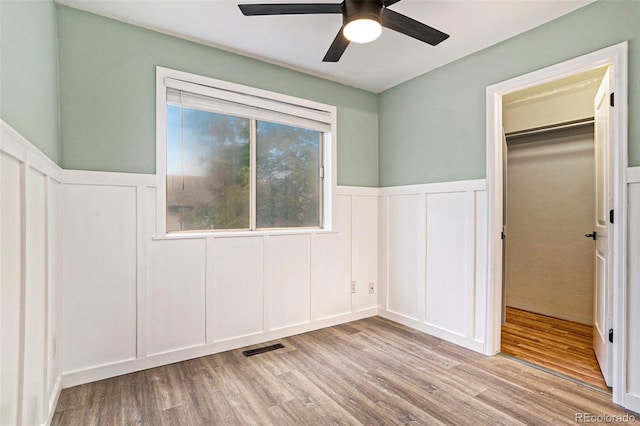 unfurnished bedroom featuring a closet, ceiling fan, and light hardwood / wood-style floors