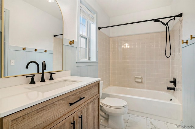 full bathroom with toilet, vanity, and tiled shower / bath