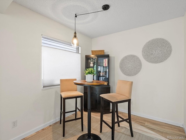 7379 S Gore Range Rd Unit 304, Littleton, CO 80127 - dining room with a textured ceiling and wood finished floors