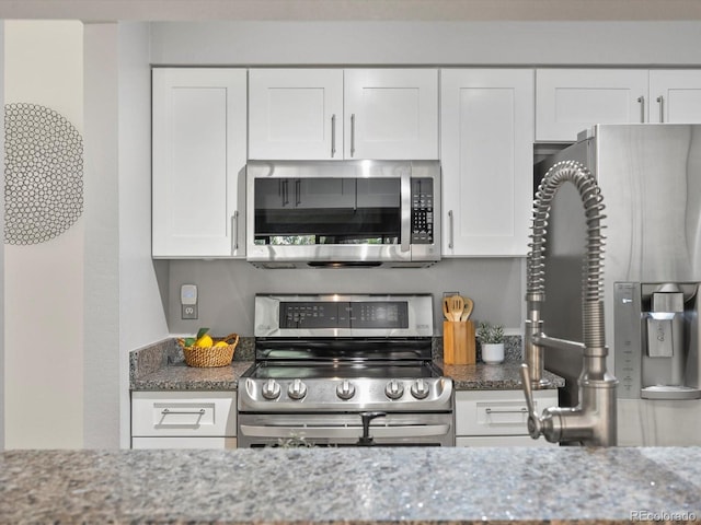 7379 S Gore Range Rd Unit 304, Littleton, CO 80127 - kitchen with stainless steel appliances, light stone countertops, and white cabinetry