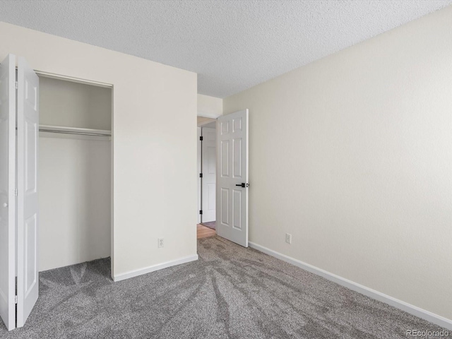 7379 S Gore Range Rd Unit 304, Littleton, CO 80127 - unfurnished bedroom with carpet flooring, a closet, and a textured ceiling