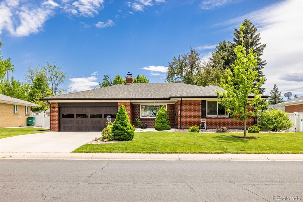 428 W Valleyview Ave, Littleton, CO 80120 - ranch-style house featuring a garage, concrete driveway, brick siding, and a chimney