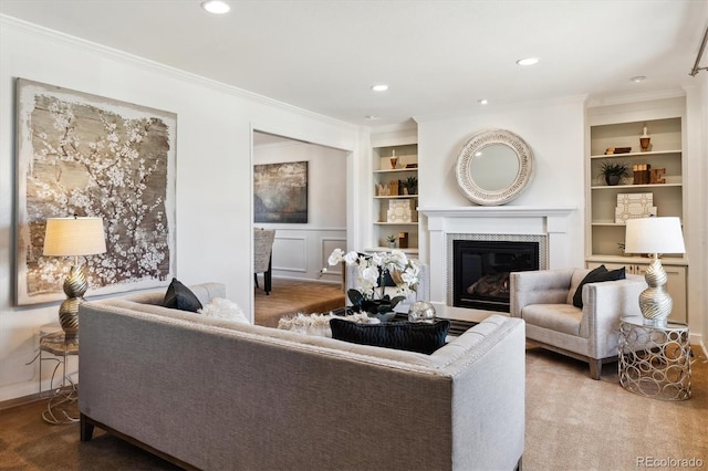 living room with built in shelves and crown molding