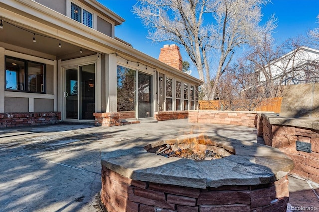 view of patio / terrace featuring an outdoor fire pit