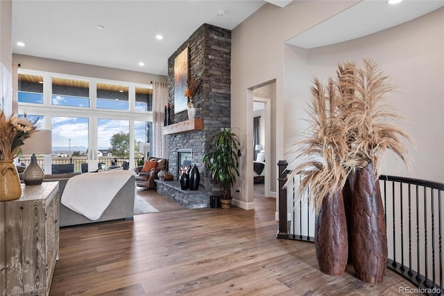 living area with recessed lighting, wood finished floors, and a fireplace