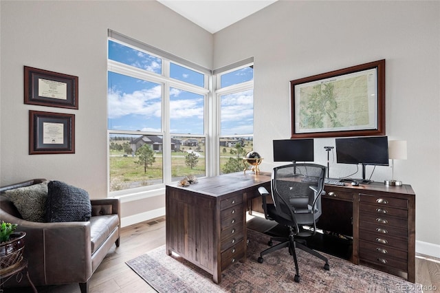 office featuring baseboards and wood finished floors