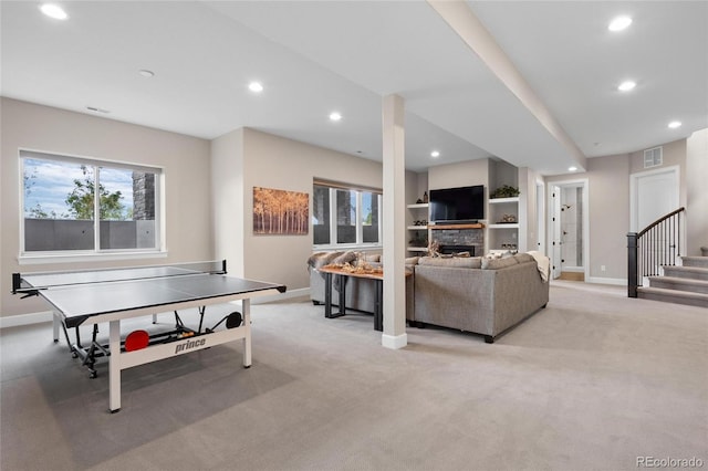 recreation room with visible vents, baseboards, recessed lighting, a stone fireplace, and light carpet