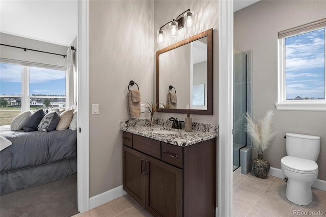 full bath with vanity, ensuite bath, toilet, and baseboards