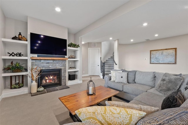 carpeted living room with visible vents, built in shelves, recessed lighting, stairway, and a fireplace