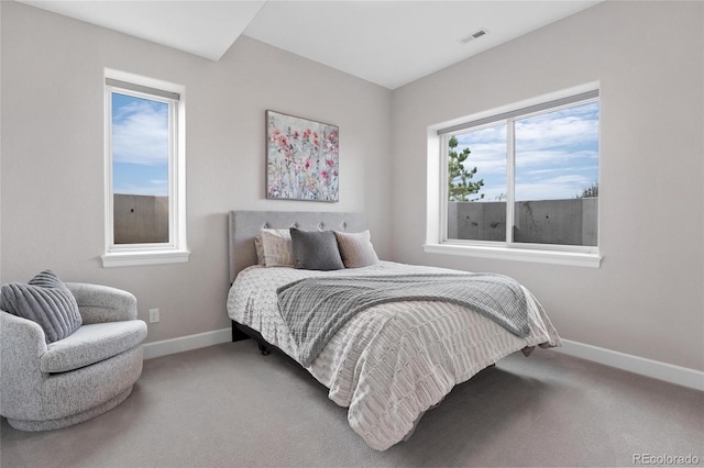 carpeted bedroom featuring visible vents and baseboards