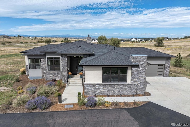 view of front of home with stucco siding, stone siding, concrete driveway, an attached garage, and a shingled roof