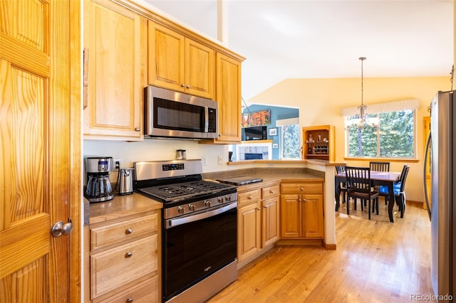 6752 S Columbine Rd, Evergreen, CO 80439 - kitchen with appliances with stainless steel finishes, light wood finished floors, a chandelier, decorative light fixtures, and vaulted ceiling