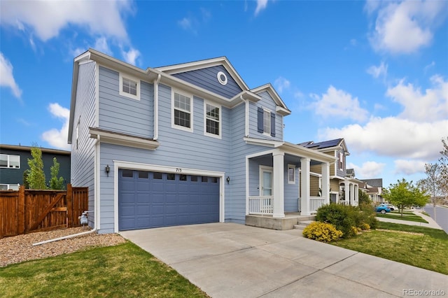 traditional home with fence, an attached garage, a porch, and driveway