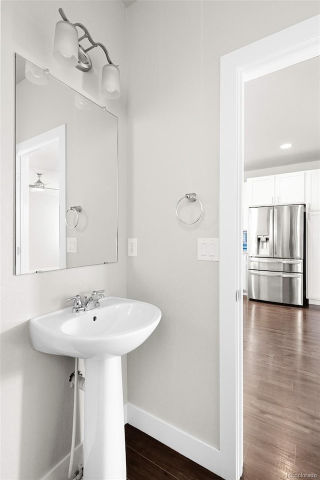 12714 E Dickenson Ave, Aurora, CO 80014 - bathroom featuring baseboards and wood finished floors