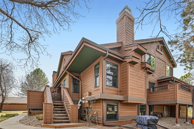 9295 W 80th Pl Unit A, Arvada, CO 80005 - view of property exterior with a chimney and stairway