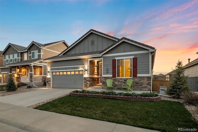 craftsman-style home with concrete driveway, board and batten siding, a garage, and stone siding