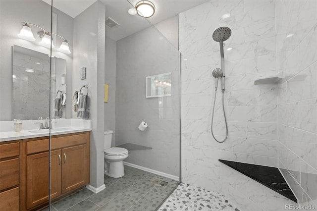 bathroom featuring vanity, baseboards, walk in shower, toilet, and visible vents