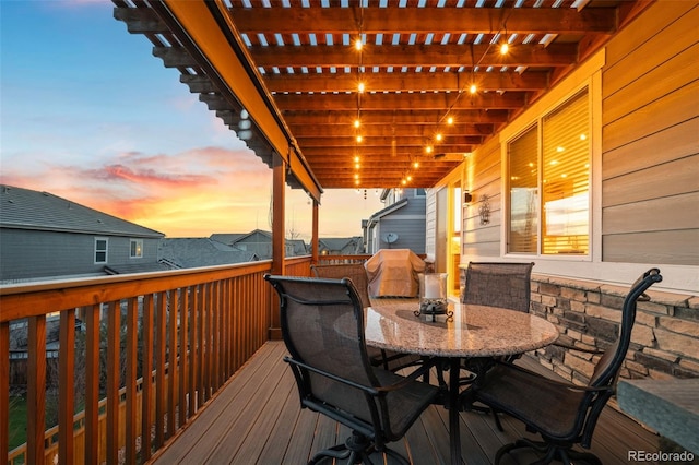 wooden terrace featuring outdoor dining space and a pergola