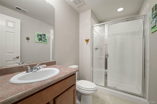 bathroom featuring visible vents, toilet, and a stall shower