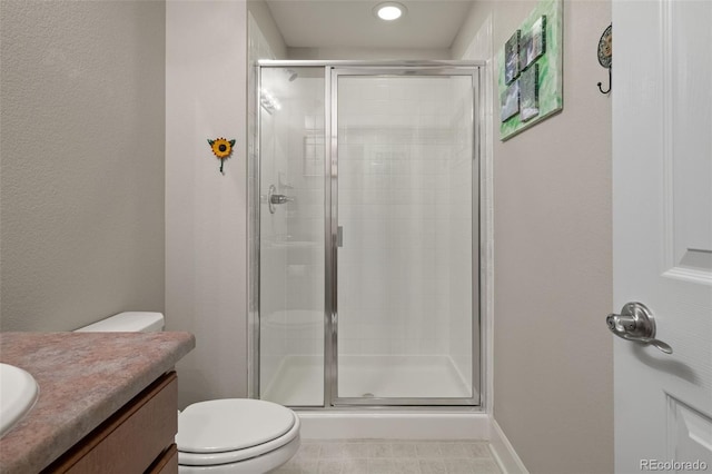 bathroom with a shower stall, vanity, recessed lighting, and toilet