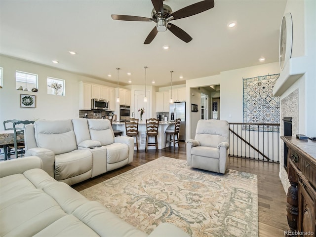 15347 Quince Cir, Thornton, CO 80602 - living area with ceiling fan, wood finished floors, recessed lighting, and a fireplace