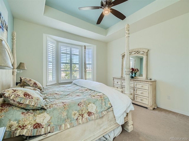15347 Quince Cir, Thornton, CO 80602 - bedroom featuring light carpet, a tray ceiling, baseboards, and ceiling fan