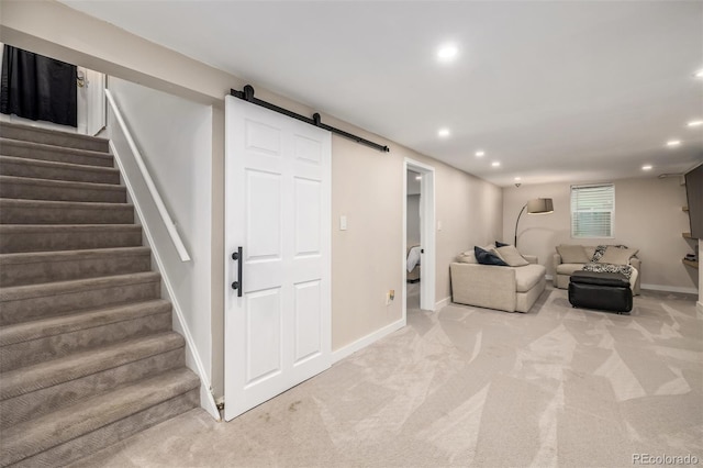 living room featuring light colored carpet and a barn door