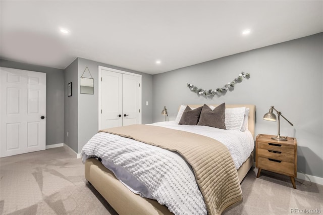 bedroom featuring light carpet and a closet