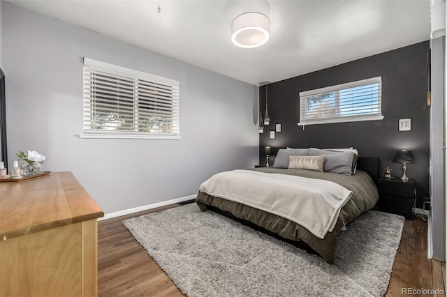 bedroom with dark wood-type flooring