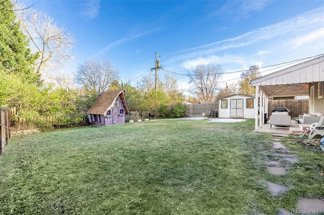 view of yard with a patio and a storage unit