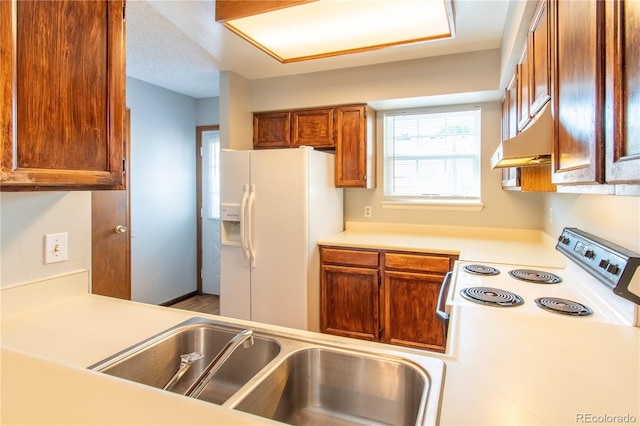 kitchen featuring white appliances and a textured ceiling