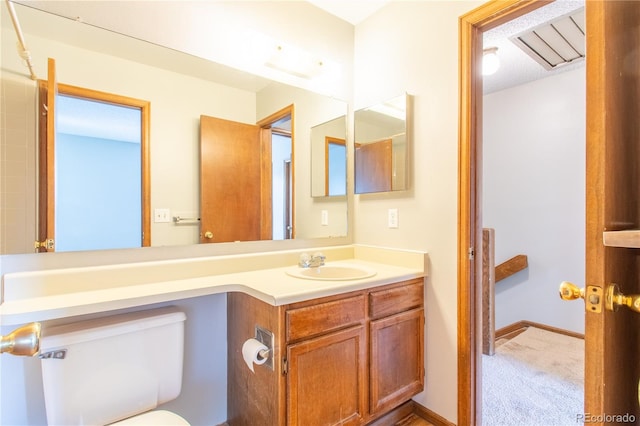 bathroom featuring vanity and toilet