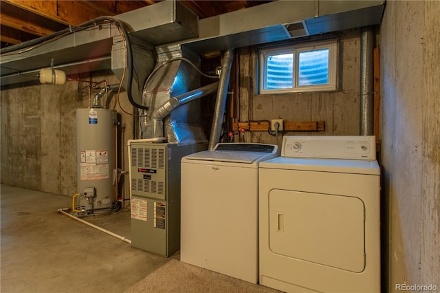 laundry room featuring gas water heater, heating unit, and washing machine and clothes dryer