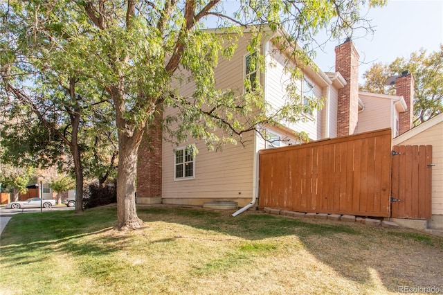 view of property exterior with a yard