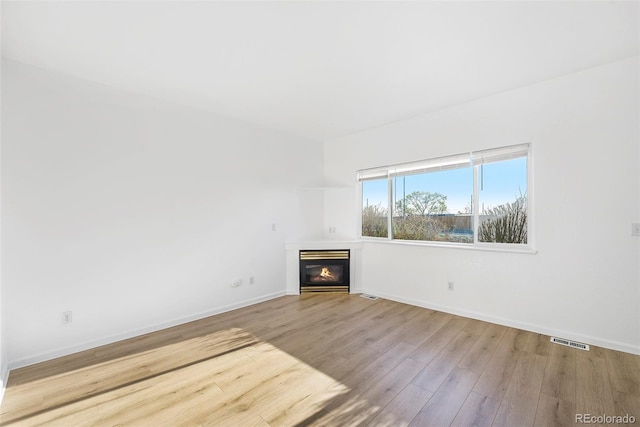 2644 Devonshire Ct, Denver, CO 80229 - unfurnished living room with wood finished floors and a glass covered fireplace