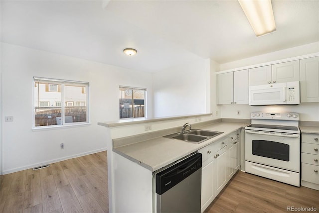 2644 Devonshire Ct, Denver, CO 80229 - kitchen with white appliances, a peninsula, light wood-style flooring, light countertops, and white cabinets
