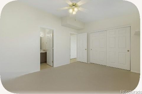 2644 Devonshire Ct, Denver, CO 80229 - unfurnished bedroom featuring a closet, ensuite bath, and ceiling fan