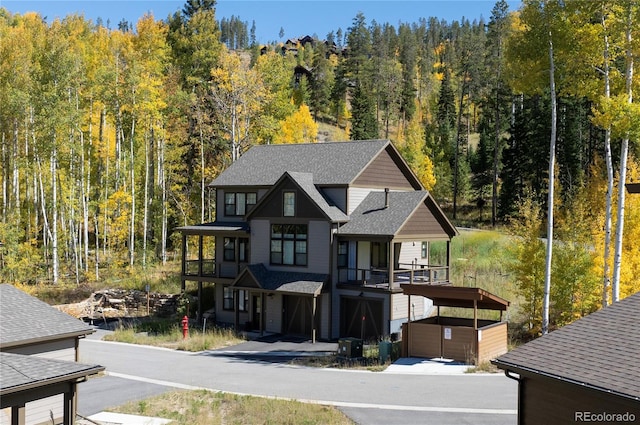 view of front facade with a garage and a balcony