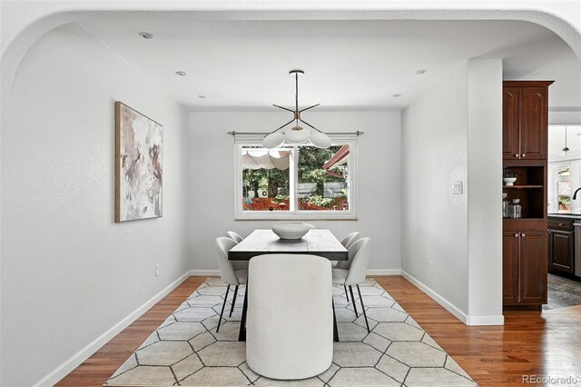 3608 S Newport Way, Denver, CO 80237 - dining area with wood finished floors and arched walkways