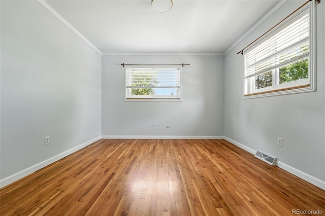 3608 S Newport Way, Denver, CO 80237 - unfurnished room featuring ornamental molding, healthy amount of natural light, and hardwood / wood-style floors