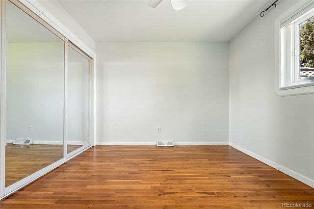 3608 S Newport Way, Denver, CO 80237 - unfurnished bedroom with wood finished floors and a closet