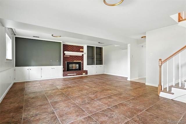 3608 S Newport Way, Denver, CO 80237 - unfurnished living room with stairs, built in features, a fireplace, and dark tile patterned floors