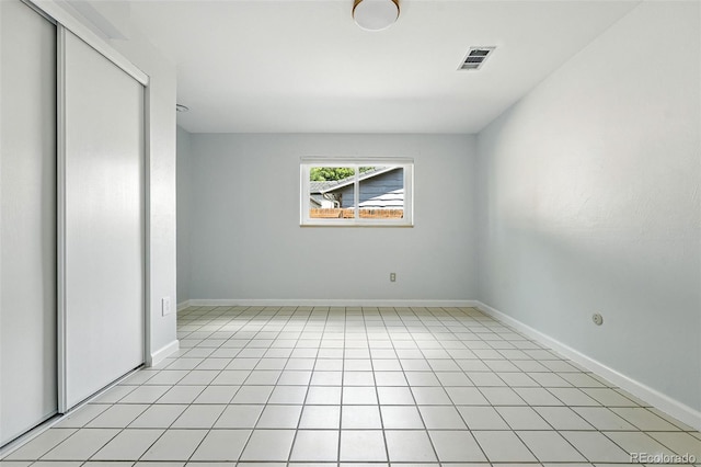 3608 S Newport Way, Denver, CO 80237 - unfurnished bedroom featuring a closet and light tile patterned floors