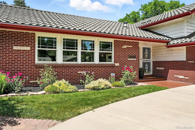 3608 S Newport Way, Denver, CO 80237 - view of front of house featuring a tile roof and brick siding