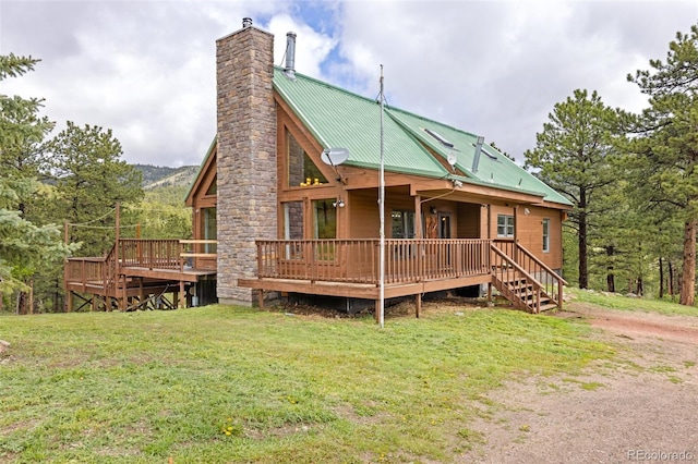 181 Sawmill Rd, Loveland, CO 80537 - rear view of property with a chimney, a yard, metal roof, and a deck