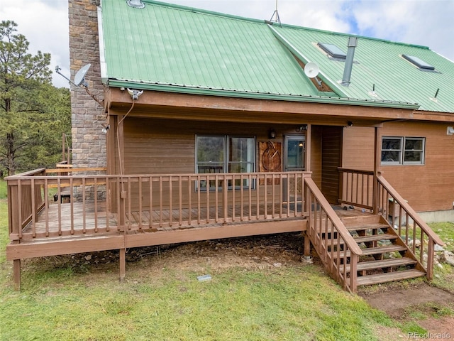 181 Sawmill Rd, Loveland, CO 80537 - rear view of house with a chimney, metal roof, and a wooden deck
