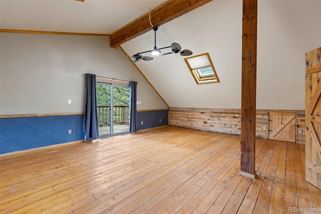 181 Sawmill Rd, Loveland, CO 80537 - additional living space featuring a skylight, wood-type flooring, wood walls, and wainscoting