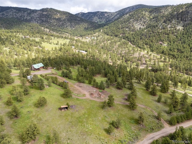 181 Sawmill Rd, Loveland, CO 80537 - aerial view of property and surrounding area with a mountain backdrop and a heavily wooded area